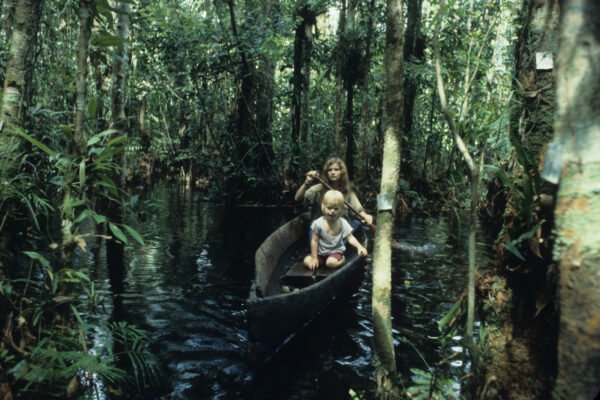 Birute and Binti in a canoe deep in the forest.