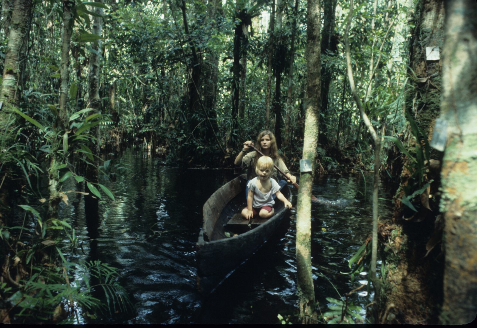 Birute and Binti in a canoe deep in the forest.